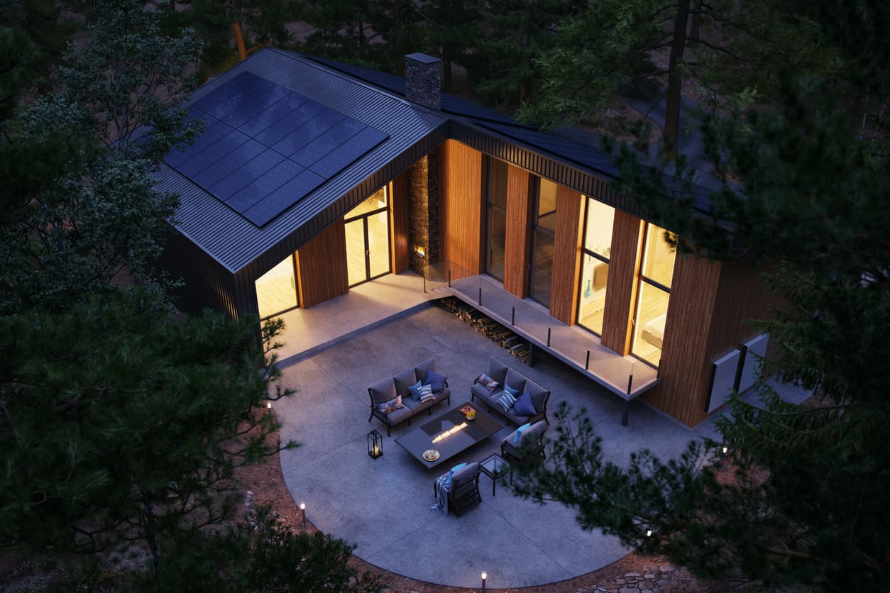 Home in the forest in the dark with lights on